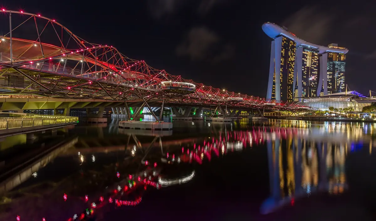 The Helix Bridge lit red at night